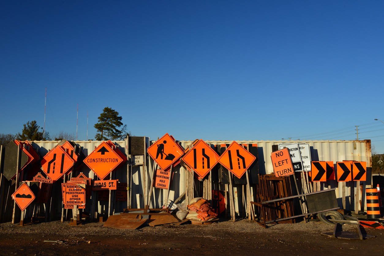 A variety of construction signs on a construction site.