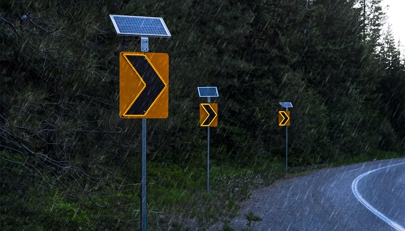 construction sign curve ahead with LED lights in rain conditions