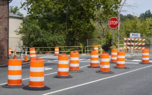 traffic barrels lined up on road for construction