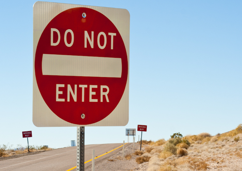 red and white do not enter sign up close on highway