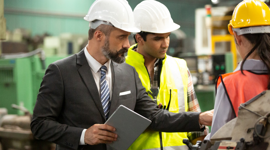 3 construction workers meeting in warehouse